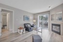 1212-5220 50A Avenue, Sylvan Lake, AB  - Indoor Photo Showing Living Room With Fireplace 