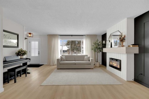 42 Valley Crescent, Lacombe, AB - Indoor Photo Showing Living Room With Fireplace