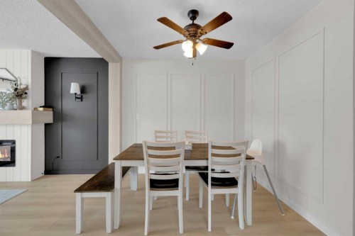 42 Valley Crescent, Lacombe, AB - Indoor Photo Showing Dining Room With Fireplace