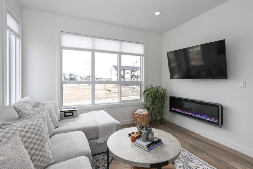 E-2 Evergreen Way, Red Deer, AB - Indoor Photo Showing Living Room With Fireplace
