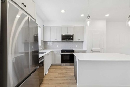 15 Emberside Park, Cochrane, AB - Indoor Photo Showing Kitchen With Double Sink With Upgraded Kitchen
