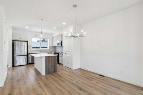 15 Emberside Park, Cochrane, AB - Indoor Photo Showing Kitchen With Upgraded Kitchen