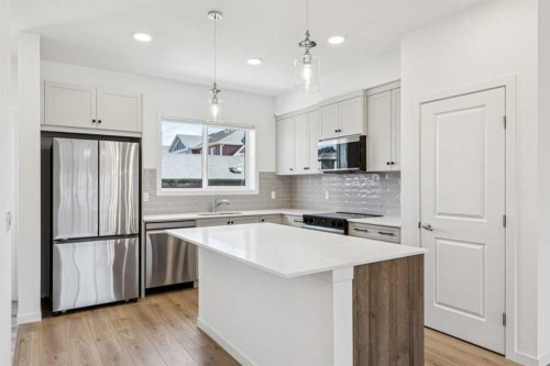 15 Emberside Park, Cochrane, AB - Indoor Photo Showing Kitchen With Upgraded Kitchen