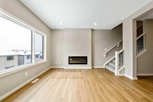 370 Heritage Boulevard, Cochrane, AB - Indoor Photo Showing Other Room With Fireplace