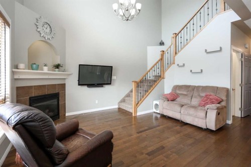 98 Pine Crescent, Blackfalds, AB - Indoor Photo Showing Living Room With Fireplace