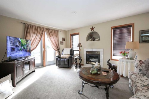 22D-32 Daines Avenue, Red Deer, AB - Indoor Photo Showing Living Room With Fireplace
