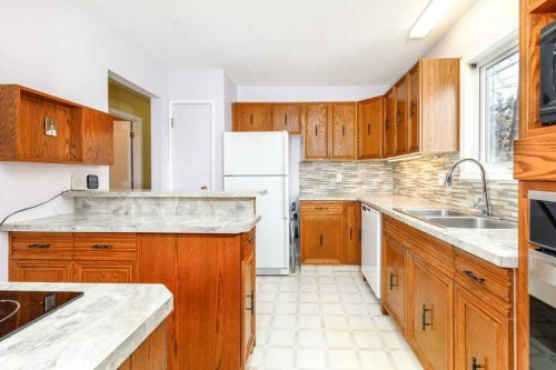 32 Greig Drive, Red Deer, AB - Indoor Photo Showing Kitchen With Double Sink