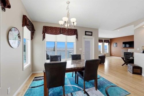 122 Sutherland Close, Red Deer, AB - Indoor Photo Showing Dining Room With Fireplace
