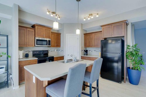 7-5301 Windward Place, Sylvan Lake, AB - Indoor Photo Showing Kitchen With Double Sink