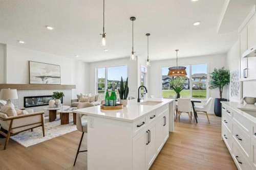 98 Creekstone Place Sw, Calgary, AB - Indoor Photo Showing Kitchen With Fireplace With Upgraded Kitchen