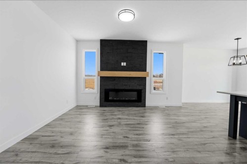 4240 Bauman Way, Innisfail, AB - Indoor Photo Showing Living Room With Fireplace