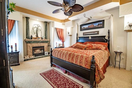 295 Jarvis Glen Close, Jarvis Bay, AB - Indoor Photo Showing Bedroom With Fireplace