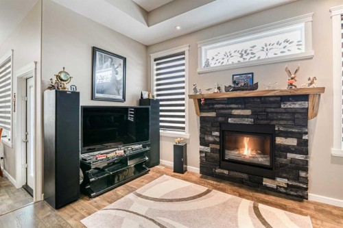 18 Mackenzie Crescent, Lacombe, AB - Indoor Photo Showing Living Room With Fireplace