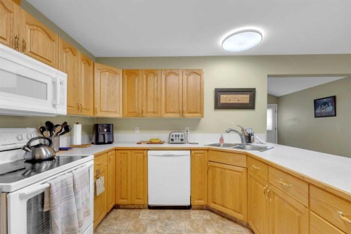 B-3621 51 Avenue, Red Deer, AB - Indoor Photo Showing Kitchen With Double Sink