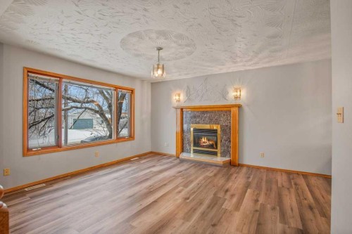 4721 46 Street, Sylvan Lake, AB - Indoor Photo Showing Living Room With Fireplace
