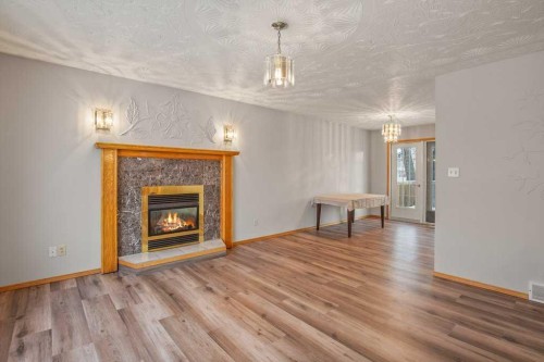 4721 46 Street, Sylvan Lake, AB - Indoor Photo Showing Living Room With Fireplace