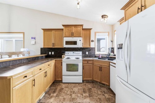 22 Mcdougall Close, Penhold, AB - Indoor Photo Showing Kitchen With Double Sink