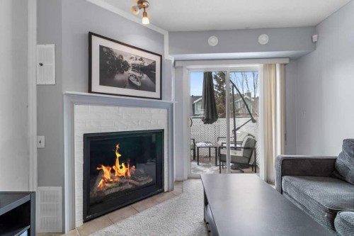 2001-5220 50A Avenue, Sylvan Lake, AB - Indoor Photo Showing Living Room With Fireplace