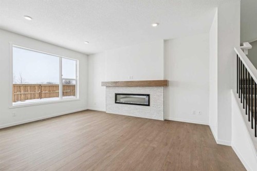 208 Southborough Common, Cochrane, AB - Indoor Photo Showing Living Room With Fireplace