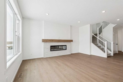 208 Southborough Common, Cochrane, AB - Indoor Photo Showing Living Room With Fireplace