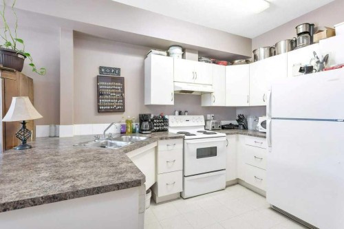 108-80A Kelloway Crescent, Red Deer, AB - Indoor Photo Showing Kitchen With Double Sink