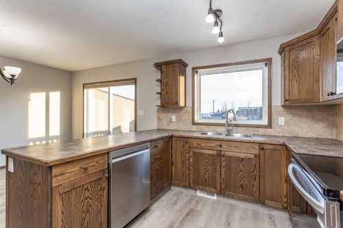 92 Iron Wolf Boulevard, Lacombe, AB - Indoor Photo Showing Kitchen With Double Sink