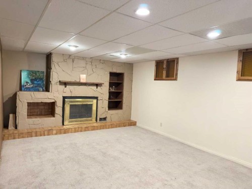 83 Barrett Drive, Red Deer, AB - Indoor Photo Showing Basement With Fireplace
