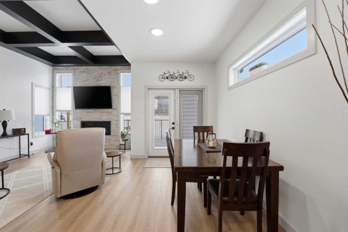 34 Mitchell Crescent, Blackfalds, AB - Indoor Photo Showing Dining Room With Fireplace