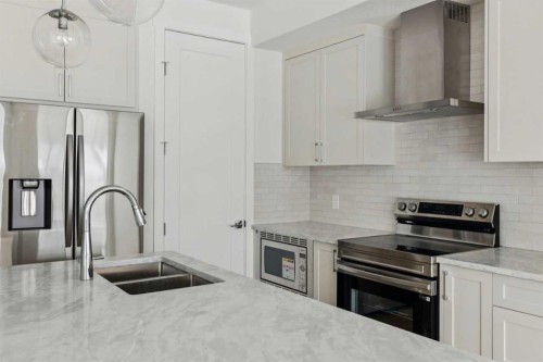 25 Linden Place, Rural Red Deer County, AB - Indoor Photo Showing Kitchen With Double Sink With Upgraded Kitchen