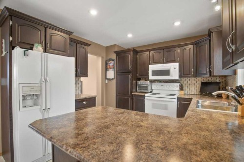 45 Ravenscrag Crescent, Norglenwold, AB - Indoor Photo Showing Kitchen With Double Sink