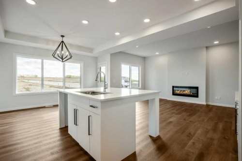 27 Heritage Link, Cochrane, AB - Indoor Photo Showing Other Room With Fireplace