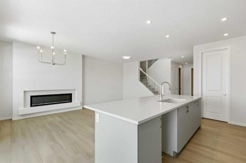 38 Annette Green Nw, Calgary, AB - Indoor Photo Showing Kitchen With Fireplace