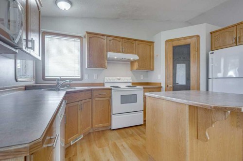 68 Herder Drive, Sylvan Lake, AB - Indoor Photo Showing Kitchen With Double Sink