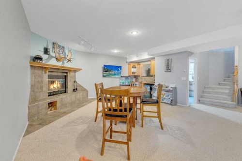 5508 49 Avenue, Alix, AB - Indoor Photo Showing Dining Room With Fireplace