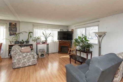 18 Hearthstone Drive, Lacombe, AB - Indoor Photo Showing Living Room With Fireplace