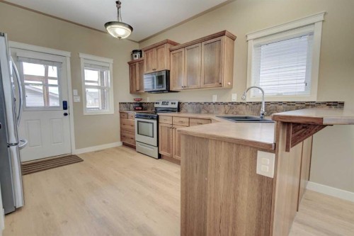 82 Harvest Close, Penhold, AB - Indoor Photo Showing Kitchen With Stainless Steel Kitchen With Double Sink