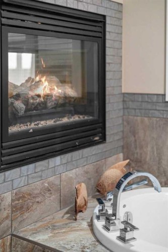 25 Leaside Crescent, Sylvan Lake, AB - Indoor Photo Showing Living Room With Fireplace