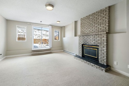 65 Macewan Ridge Circle Nw, Calgary, AB - Indoor Photo Showing Living Room With Fireplace