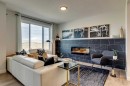 64 Southborough Common, Cochrane, AB  - Indoor Photo Showing Living Room With Fireplace 