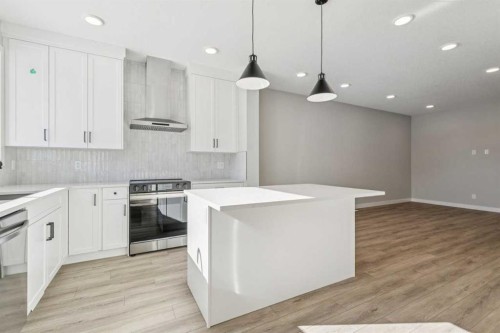 335 Fireside Drive, Cochrane, AB - Indoor Photo Showing Kitchen With Upgraded Kitchen
