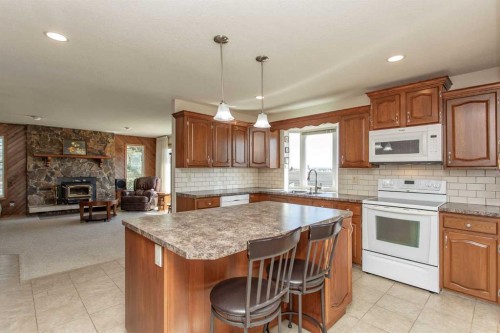13 43 Avenue Close, Lacombe, AB - Indoor Photo Showing Kitchen With Fireplace
