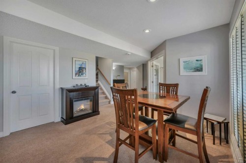 82 Ingram Close, Red Deer, AB - Indoor Photo Showing Dining Room With Fireplace