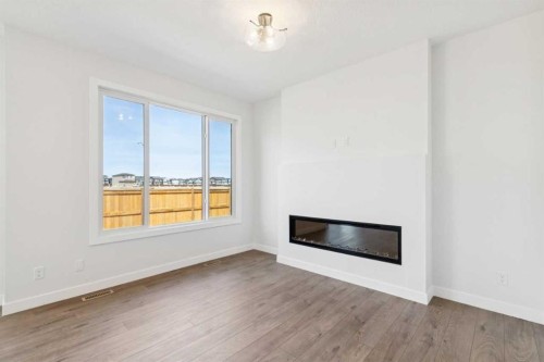 599 Buffaloberry Manor Se, Calgary, AB - Indoor Photo Showing Other Room With Fireplace