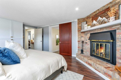 11 Pearson Crescent, Red Deer, AB - Indoor Photo Showing Bedroom With Fireplace