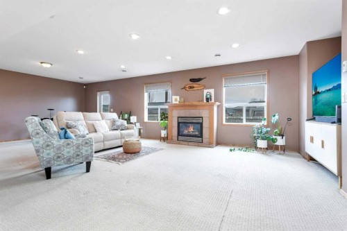 74 Fulmar Close, Sylvan Lake, AB - Indoor Photo Showing Other Room With Fireplace