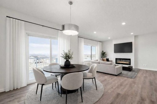 8 Heritage Link, Cochrane, AB - Indoor Photo Showing Dining Room With Fireplace