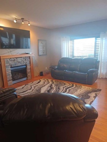31 Oaklands Crescent, Red Deer, AB - Indoor Photo Showing Living Room With Fireplace