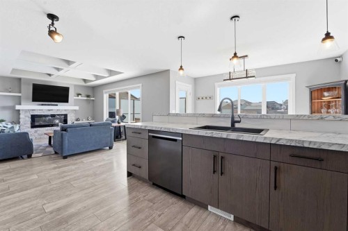 11 Aura Drive, Blackfalds, AB - Indoor Photo Showing Kitchen With Fireplace With Upgraded Kitchen