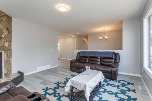 103 Westview Drive, Sylvan Lake, AB - Indoor Photo Showing Living Room With Fireplace