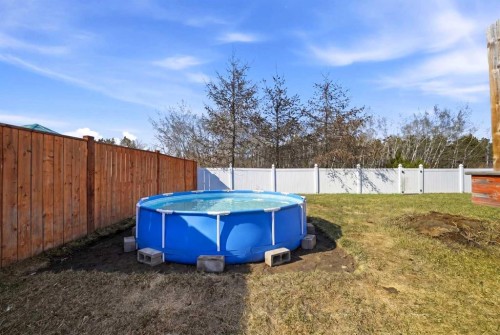 113 Coachman Way, Blackfalds, AB - Outdoor With Above Ground Pool With Backyard